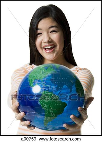Stock Photo - Teenage girl standing with a globe. Fotosearch