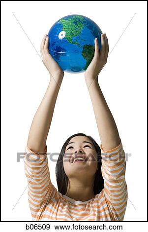 Teenage girl standing with a globe View Large Photo Image Stock Photo - Teenage girl standing with a globe. Fotosearch