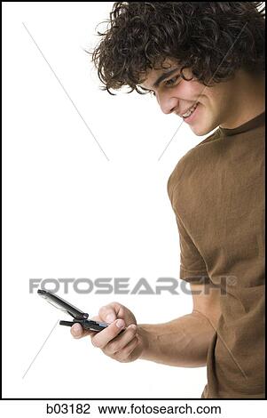 Teenager boy holding cell phone View Large Photo Image Stock Image - Teenager boy holding cell phone. Fotosearch