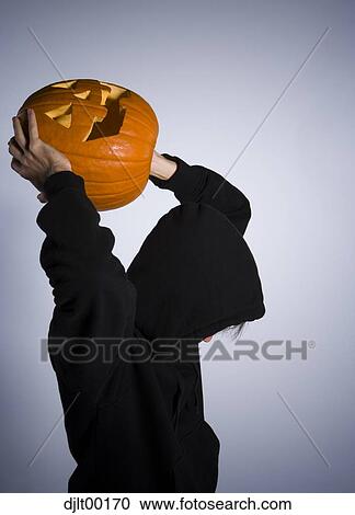 The Grim Reaper throwing a jack-o-lantern View Large Photo Image Stock Image - The Grim Reaper throwing a jack-o-lantern. Fotosearch