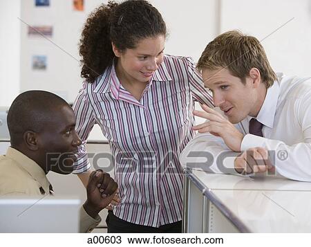 Three Business People Gossiping Stock Image A Fotosearch