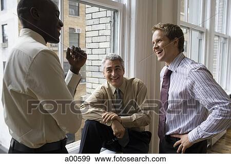 Three businessmen talking and laughing View Large Photo Image Stock Photo - Three businessmen talking and laughing. Fotosearch