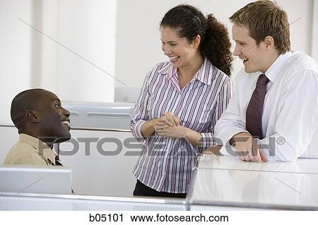 Three coworkers talking View Large Photo Image Stock Image - Three coworkers talking. Fotosearch
