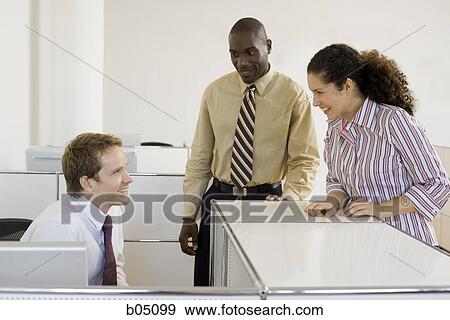 Stock Photo - Three coworkers talking. Fotosearch