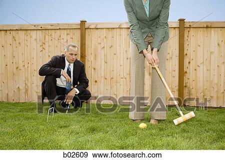 Two businesspeople playing croquet View Large Photo Image Stock Photo - Two businesspeople playing croquet. Fotosearch