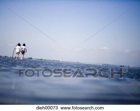 Two female children wading View Large Photo Image Stock Image - Two female children wading. Fotosearch