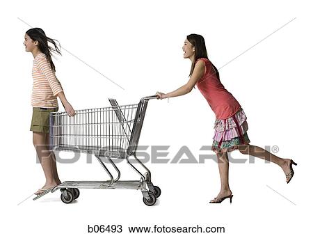 Two females playing with a shopping cart View Large Photo Image Stock Image - Two females playing with a shopping cart. Fotosearch