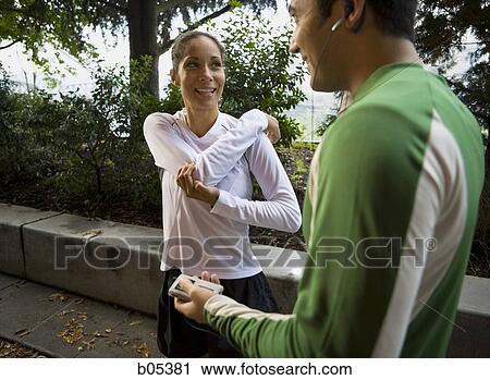 Stock Image - Two joggers stretching. Fotosearch