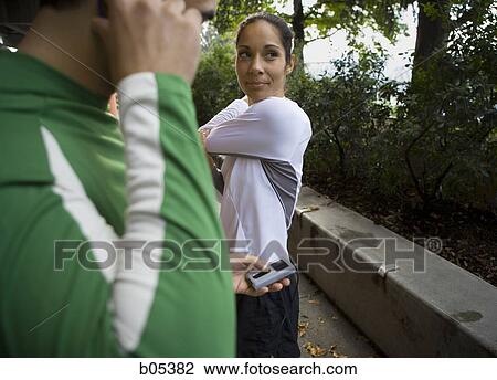 Two joggers stretching View Large Photo Image Stock Image - Two joggers stretching. Fotosearch