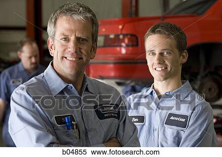 Stock Photography - Two mechanics posing and smiling. Fotosearch