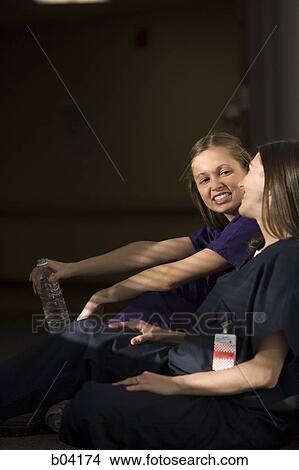 Two nurses sitting and talking View Large Photo Image Picture - Two nurses sitting and talking. Fotosearch