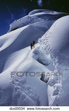 Picture - Two people on snow mountain. Fotosearch