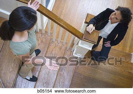 Two women arguing on staircase View Large Photo Image Picture - Two women arguing on staircase. Fotosearch