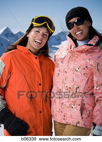 Two women outside in the snow View Large Photo Image Stock Photo - Two women outside in the snow. Fotosearch