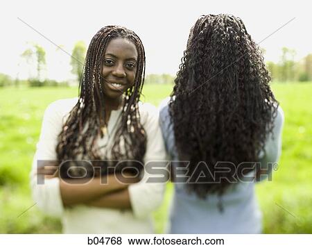 Stock Photo - Two women standing in a field. Fotosearch