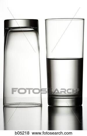 Stock Photo - Upside down glass and glass of water. Fotosearch
