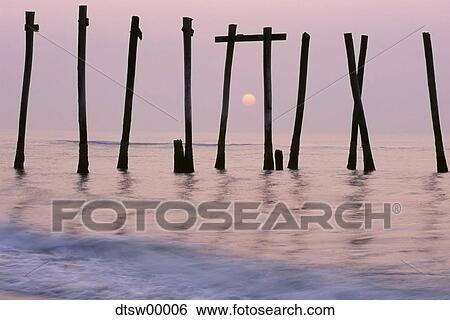 Water at sunrise or sunset with dead trees View Large Photo Image Stock Photograph - Water at sunrise or sunset with dead trees. Fotosearch