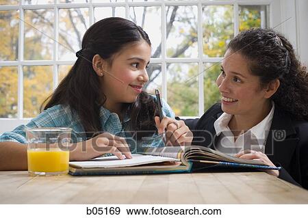 Stock Photo - Woman and girl doing homework. Fotosearch