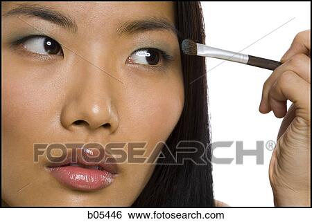 Woman applying eyeshadow with makeup brush View Large Photo Image Stock Photograph - Woman applying eyeshadow with makeup brush. Fotosearch