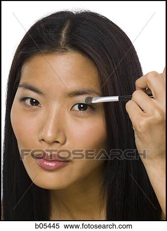 Woman applying eyeshadow with makeup brush View Large Photo Image Stock Photography - Woman applying eyeshadow with makeup brush. Fotosearch
