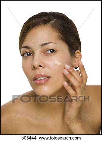 Picture - Woman applying foundation. Fotosearch