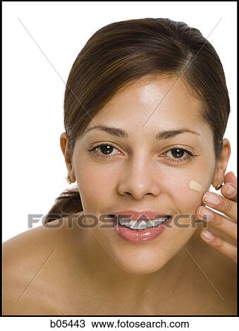 Woman applying foundation smiling View Large Photo Image Stock Image - Woman applying foundation smiling. Fotosearch