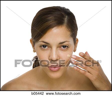 Stock Image - Woman applying foundation. Fotosearch