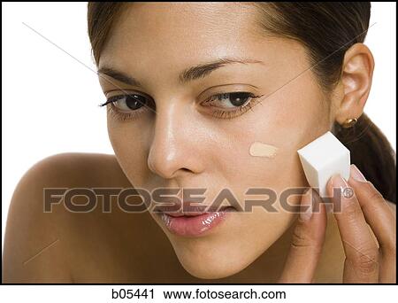 Woman applying foundation with makeup sponge View Large Photo Image Stock Image - Woman applying foundation with makeup sponge. Fotosearch