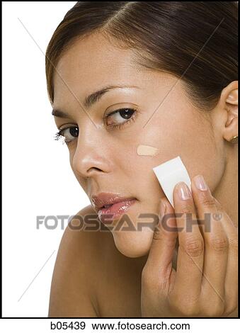 Woman applying foundation with makeup sponge View Large Photo Image Stock Photo - Woman applying foundation with makeup sponge. Fotosearch
