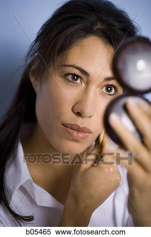 Woman applying makeup with powder puff and compact View Large Photo Image Stock Photography - Woman applying makeup with powder puff and compact. Fotosearch
