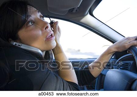 Woman applying mascara in a car View Large Photo Image Stock Image - Woman applying mascara in a car. Fotosearch