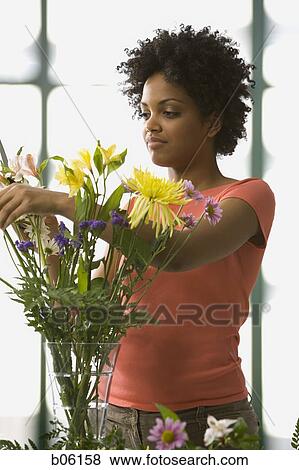 Stock Photo - Woman arranging flowers. Fotosearch