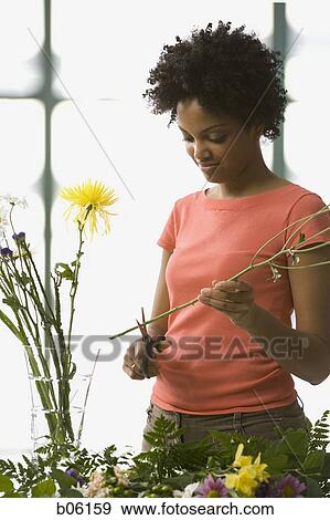 Stock Photo - Woman arranging flowers. Fotosearch
