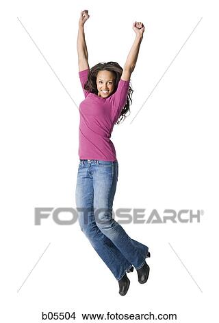 Picture - Woman casually dressed jumping. Fotosearch