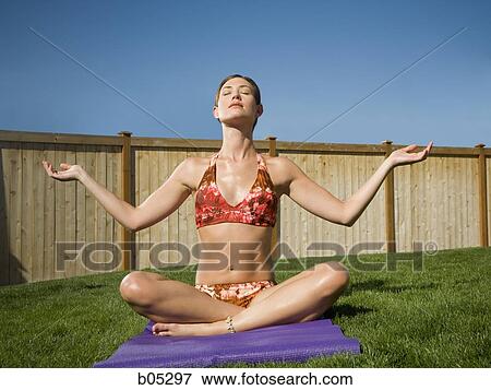 Woman doing yoga in yard with blue sky View Large Photo Image Stock Photo - Woman doing yoga in yard with blue sky. Fotosearch
