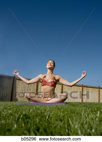 Woman doing yoga in yard with blue sky View Large Photo Image Stock Photograph - Woman doing yoga in yard with blue sky. Fotosearch