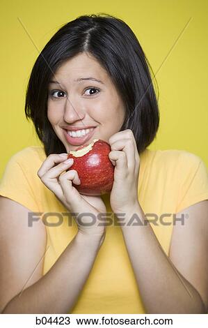 Woman eating a red apple View Large Photo Image Stock Image - Woman eating a red apple. Fotosearch