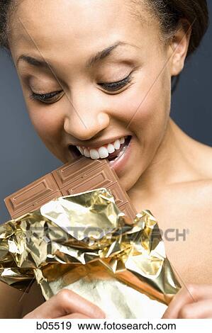 Woman eating chocolate bar View Large Photo Image Stock Photo - Woman eating chocolate bar. Fotosearch