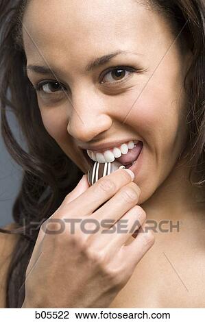 Woman eating chocolate View Large Photo Image Stock Image - Woman eating chocolate. Fotosearch