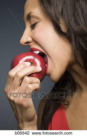 Woman eating red apple View Large Photo Image Stock Image - Woman eating red apple. Fotosearch