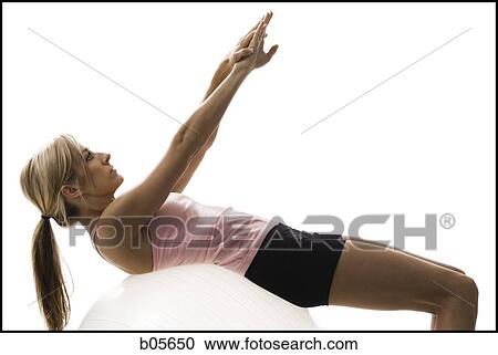 Woman exercising with a pilates ball View Large Photo Image Stock Image - Woman exercising with a pilates ball. Fotosearch