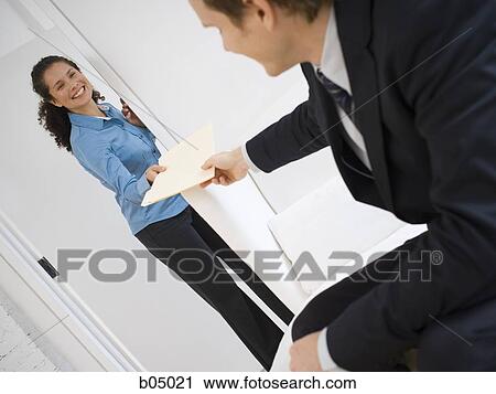 Stock Image - Woman giving businessman file folder. Fotosearch