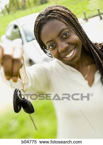 Woman giving car keys outdoors View Large Photo Image Stock Photography - Woman giving car keys outdoors. Fotosearch