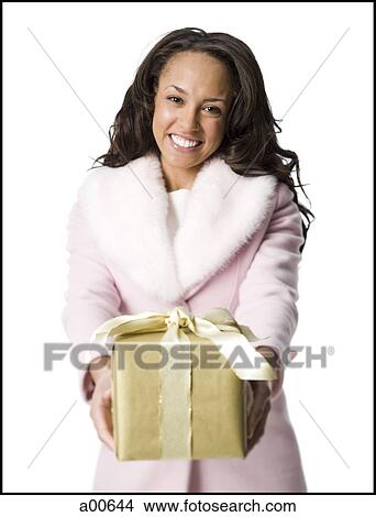 Woman giving Christmas gift View Large Photo Image Picture - Woman giving Christmas gift. Fotosearch