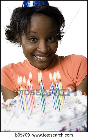 Stock Photo - Woman holding a birthday cake. Fotosearch