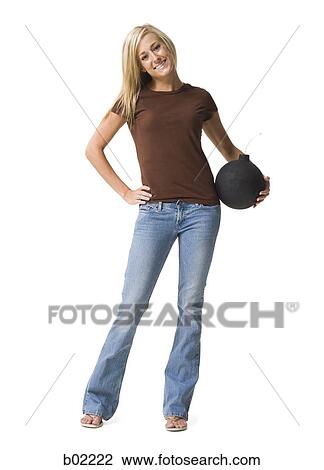 Stock Image - Woman holding a black ball. Fotosearch