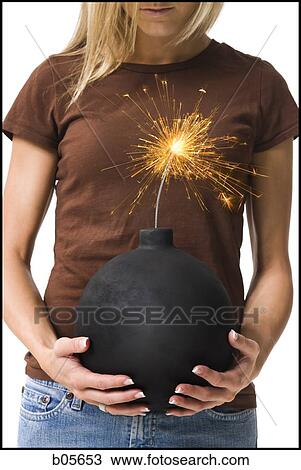 Woman holding a cannonball View Large Photo Image Stock Image - Woman holding a cannonball. Fotosearch