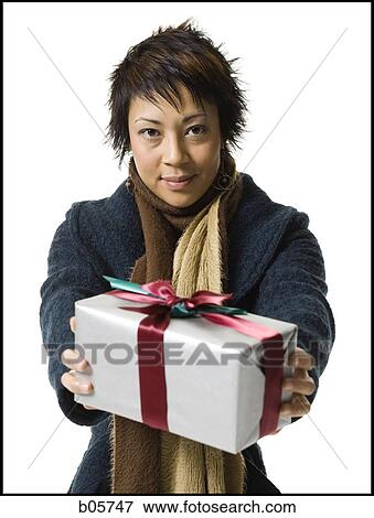 Stock Photo - Woman holding a gift. Fotosearch