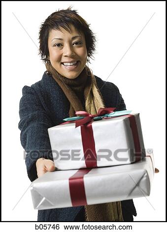 Woman holding a gift View Large Photo Image Stock Photograph - Woman holding a gift. Fotosearch