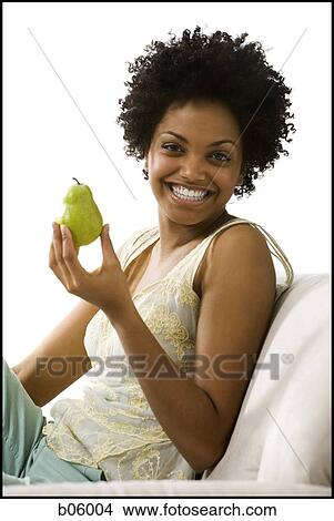 Woman holding a pear View Large Photo Image Picture - Woman holding a pear. Fotosearch